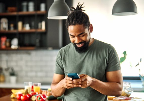 Man on mobile phone in kitchen